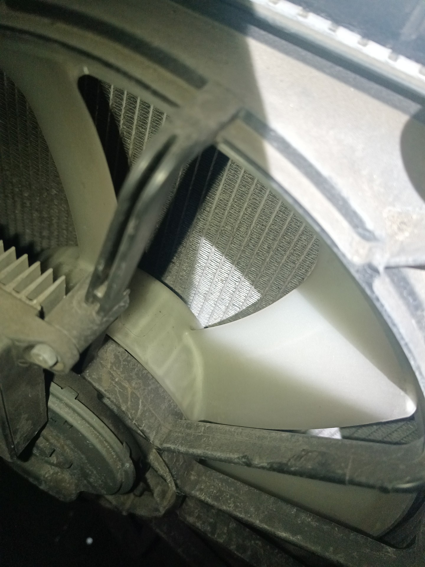 Fragment chłodnicy cieczy Mazdy CX-3 widoczny za wentylatorem i jego obudową